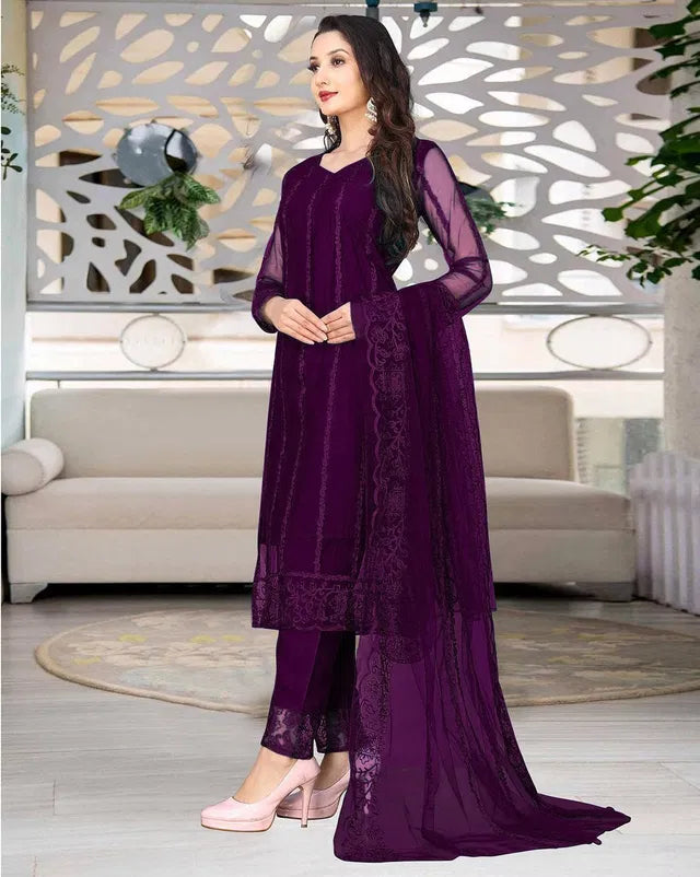 Womens kurta set with matching dupatta and bottomwear, featuring intricate embroidery and vibrant colors on the fabric.