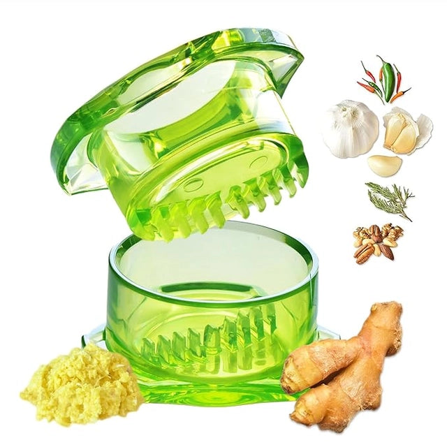 Plastic garlic crusher from 4485 kitchen tool set, showing a close-up of the handheld garlic mincer with textured pressing surface.
