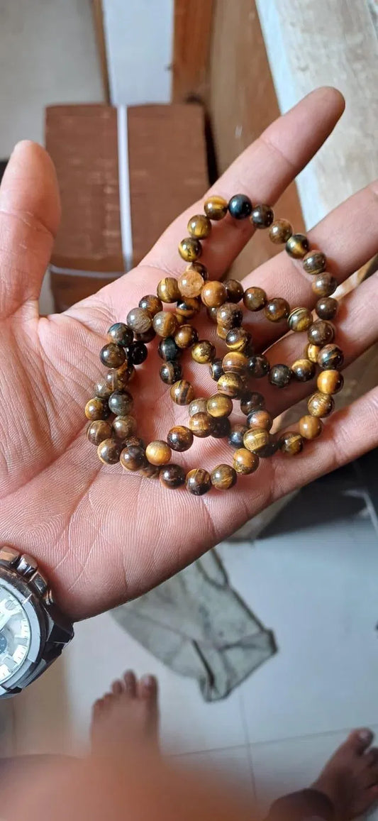 Yellow Tiger Eye crystal healing stone bracelet for men featuring polished beads and a comfortable elastic band.