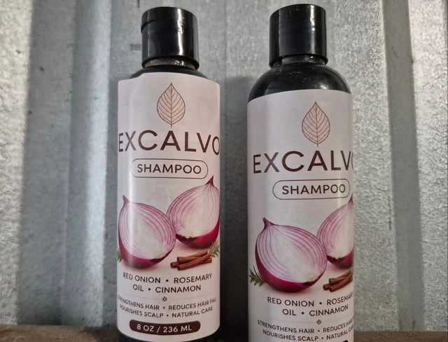 Pair of Excalvo Onion Shampoo bottles by 35912 with labels, showcasing clear bottles and shampoo inside.