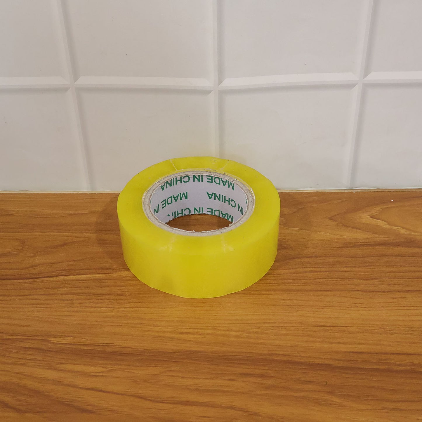 Wukusy transparent adhesive tape roll, 125x45mm, with clear packaging tape shown unrolled on a surface.