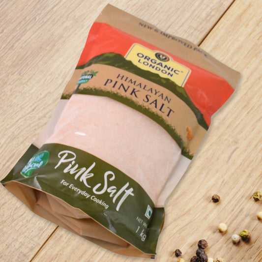 Organic Himalayan pink salt crystals in a 1 kg bag by Wukusy, showcasing pink mineral-rich salt with a natural, coarse texture.