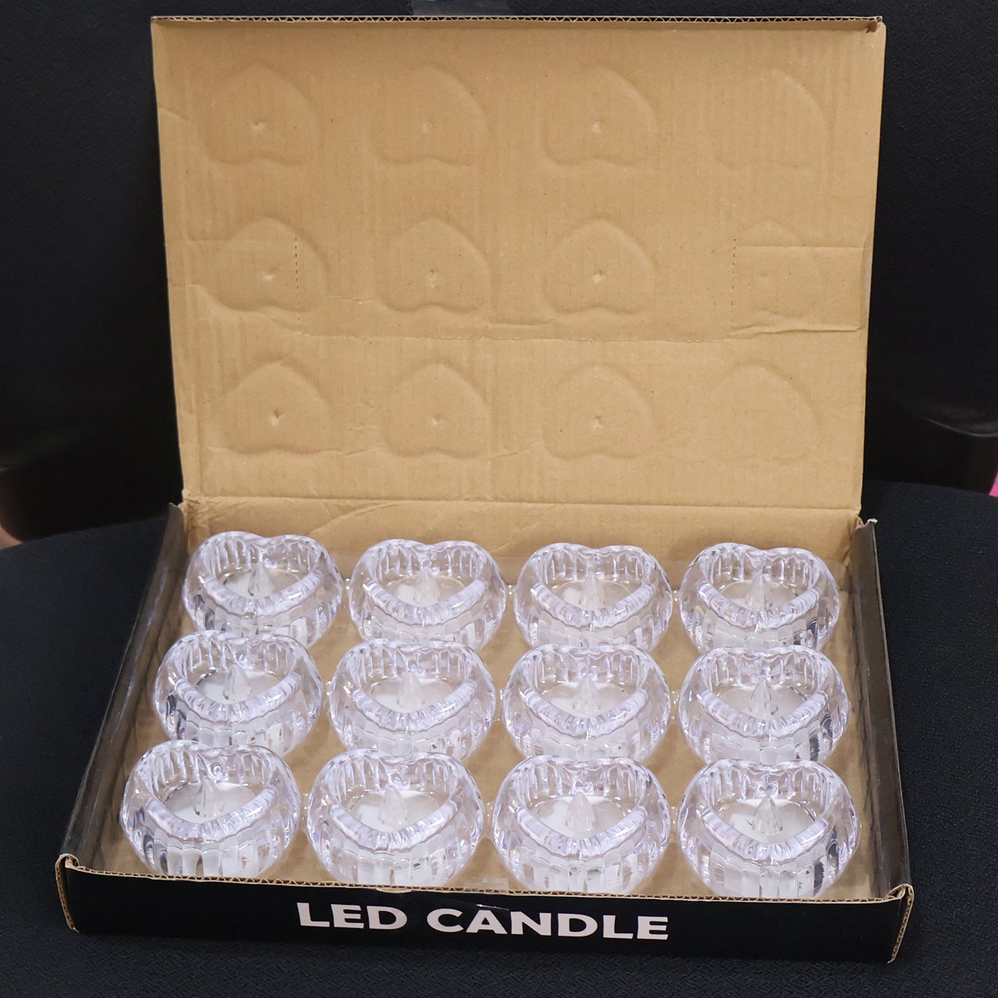 Set of 12 heart-shaped LED flameless decorative candles by Wukusy, with warm glowing light and realistic wax appearance.