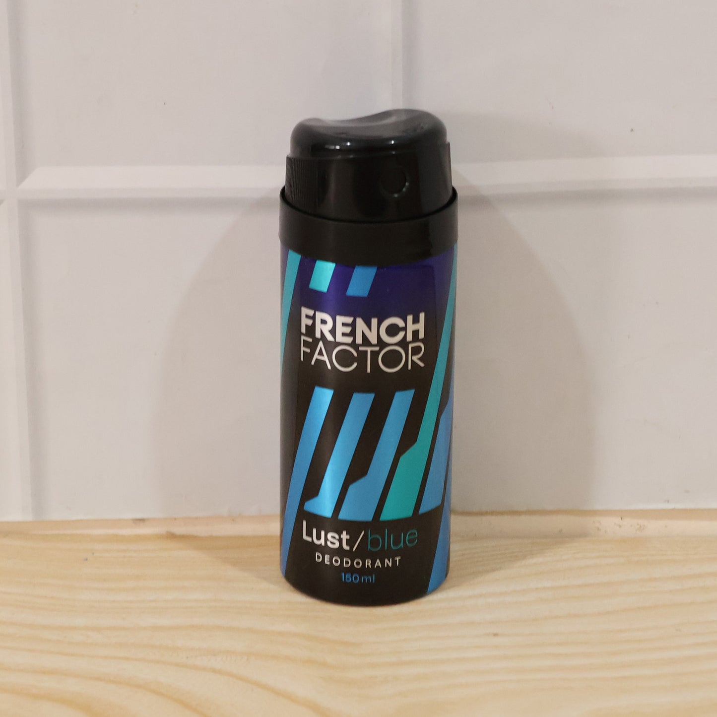 Wukusy French Factor Lust Blue deodorant body spray bottle, 150ml, with blue and silver packaging and spray nozzle.