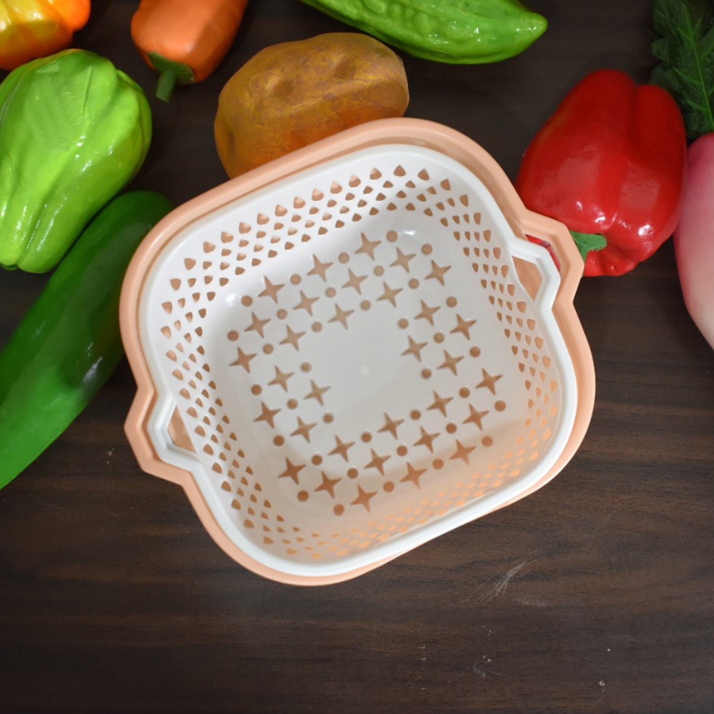 Wukusy 2-in-1 basket strainer for rinsing fruits, vegetables, and other items with a mesh design and ergonomic handles.
