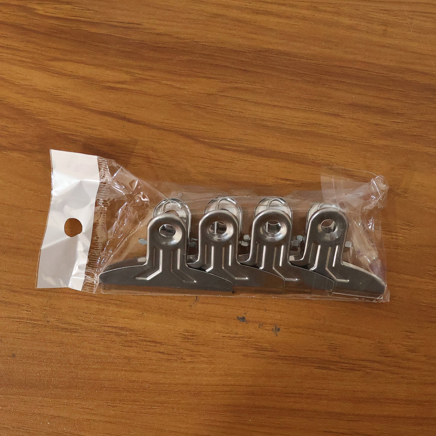 Set of four heavy-duty metal paper clamp clips by Wukusy, showing sturdy metal clips with spring-loaded grips for secure paper holding.