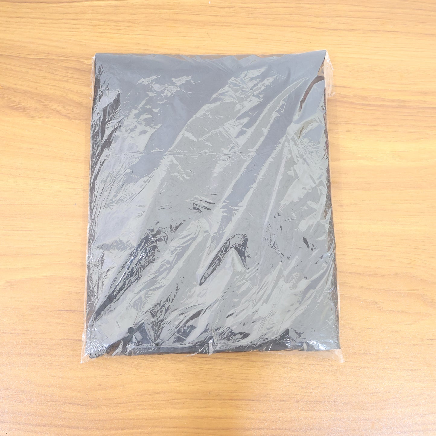 Wukusy professional hair cutting cape for salon or home use, lightweight black fabric with adjustable neck closure.