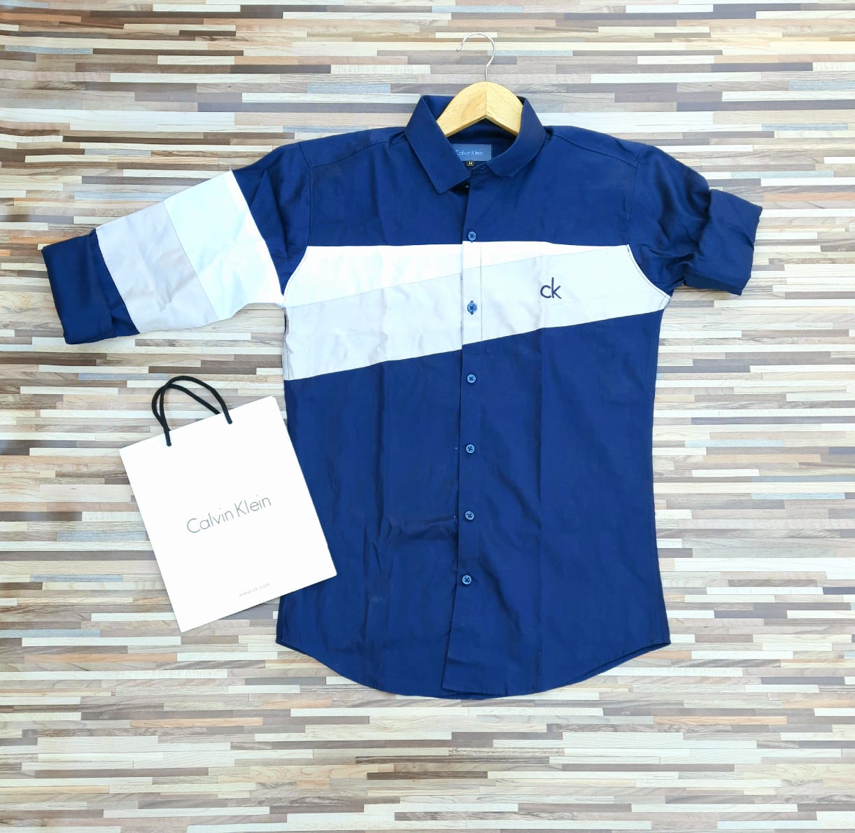 Seasons designer blue twill straight men's shirt displayed on a hanger, showcasing classic collar and button-down front.