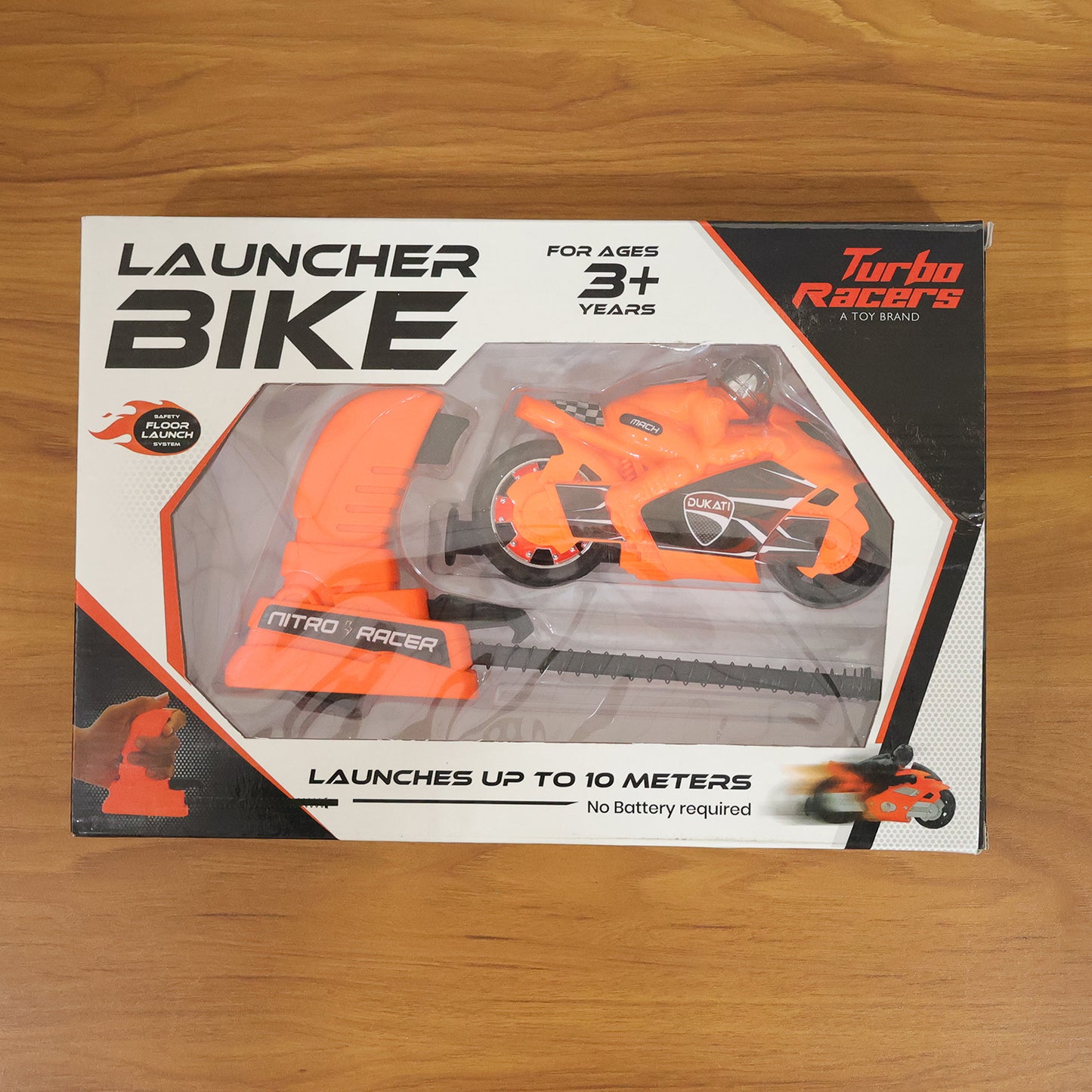 Wukusy launcher bike racing toy for kids with manual pull launcher, showing colorful, small bike and launcher mechanism in action.