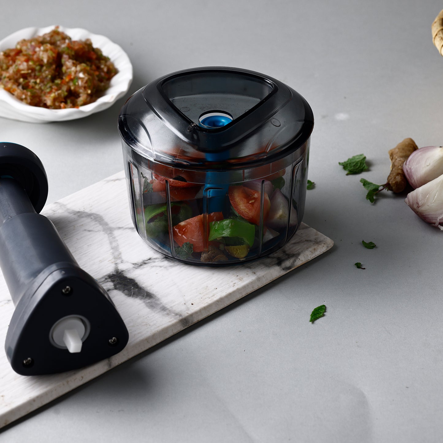 Wukusy Ganesh Bingo Lock-unlock Push Chopper in 725ml with Ganesh design, featuring a clear container and lid for easy chopping.