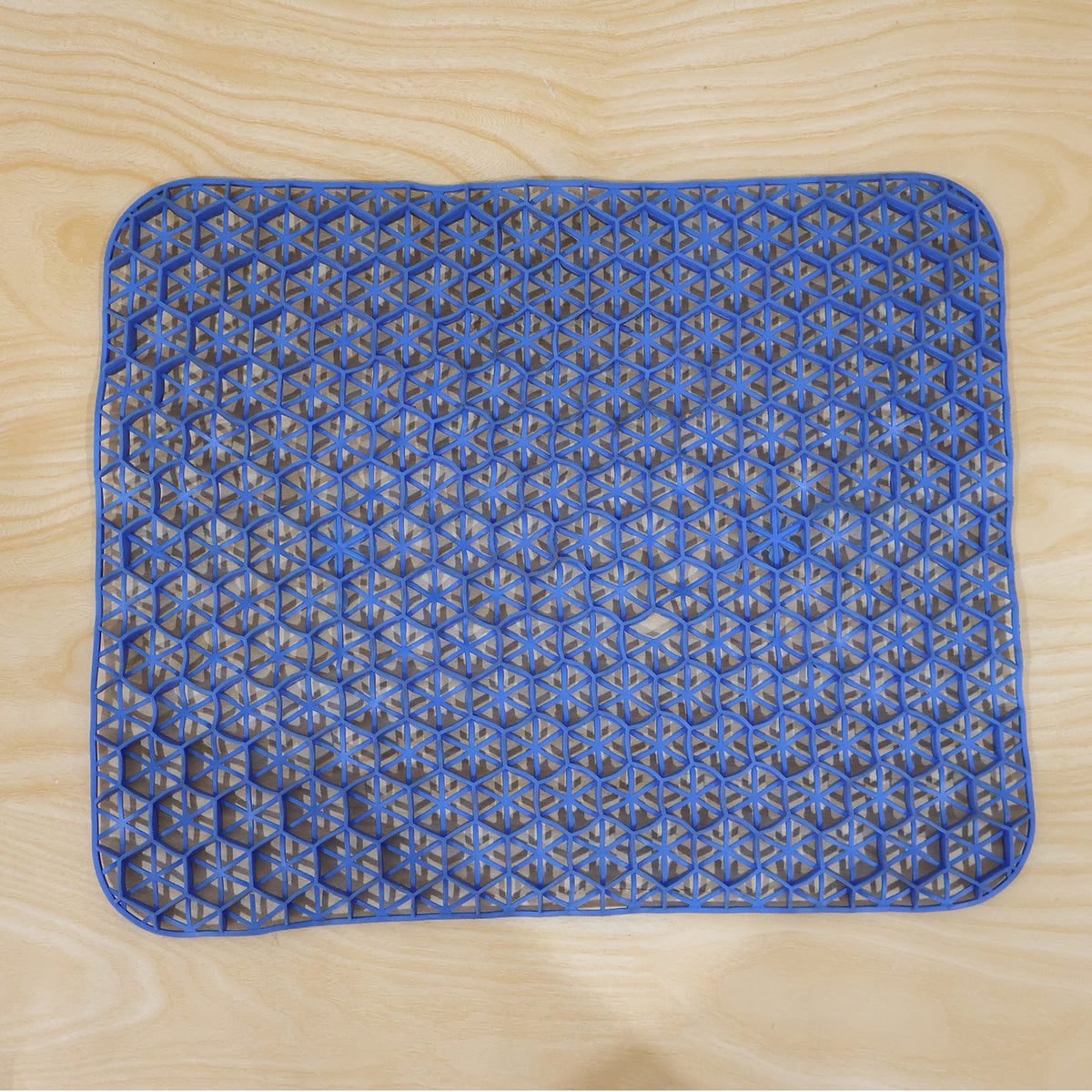 Wukusy honeycomb gel egg sitter cushion on an office chair, showing its breathable honeycomb design for comfort and support.