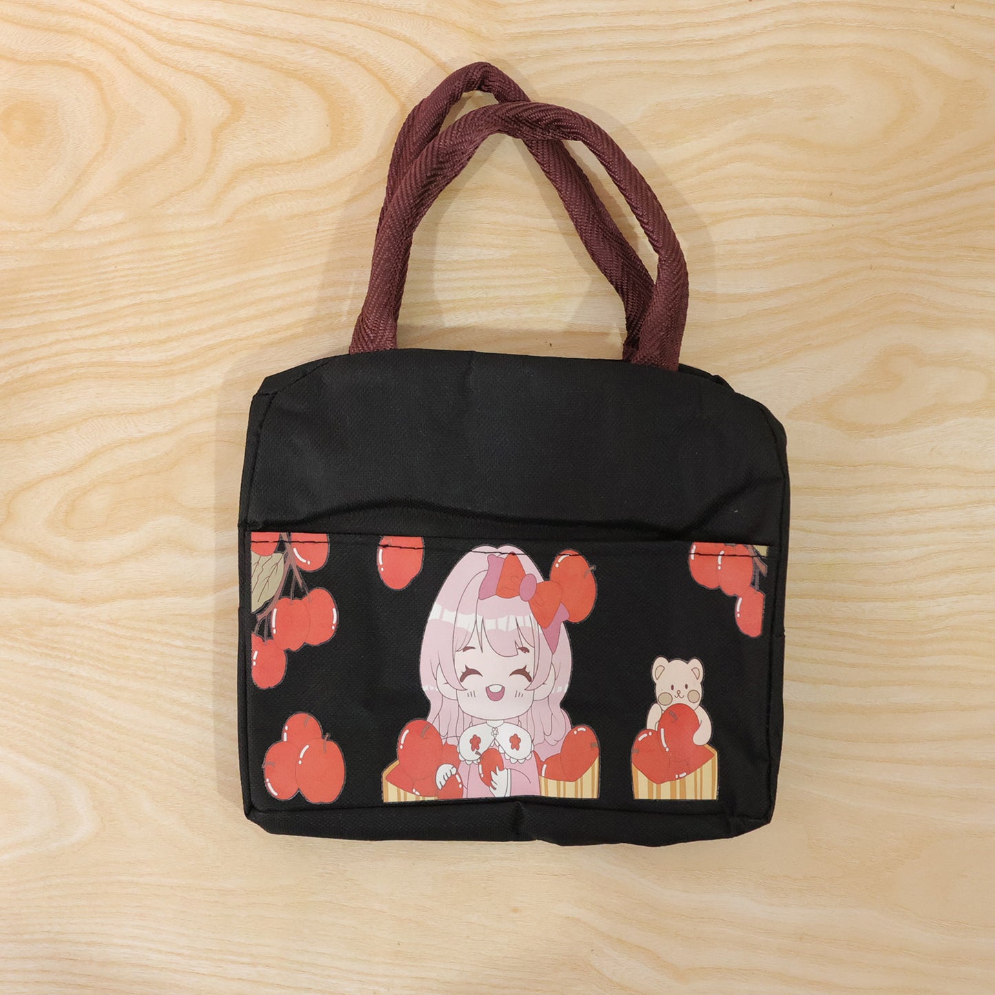 Wukusy insulated lunch bag with a cute cartoon design, featuring colorful characters and a zipper closure for easy carrying.
