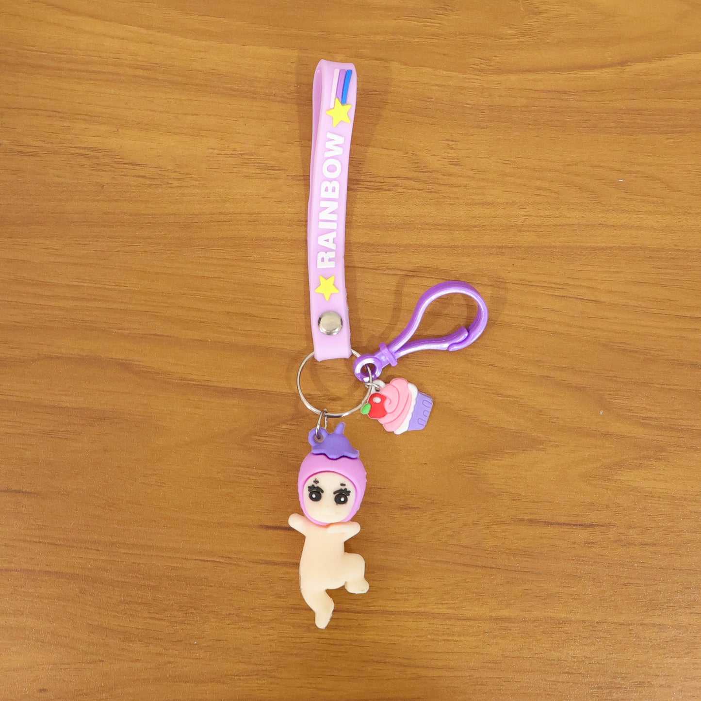 Cute Wukusy doll cupcake keychain with rainbow strap, featuring a colorful and charming design for bags or keys.