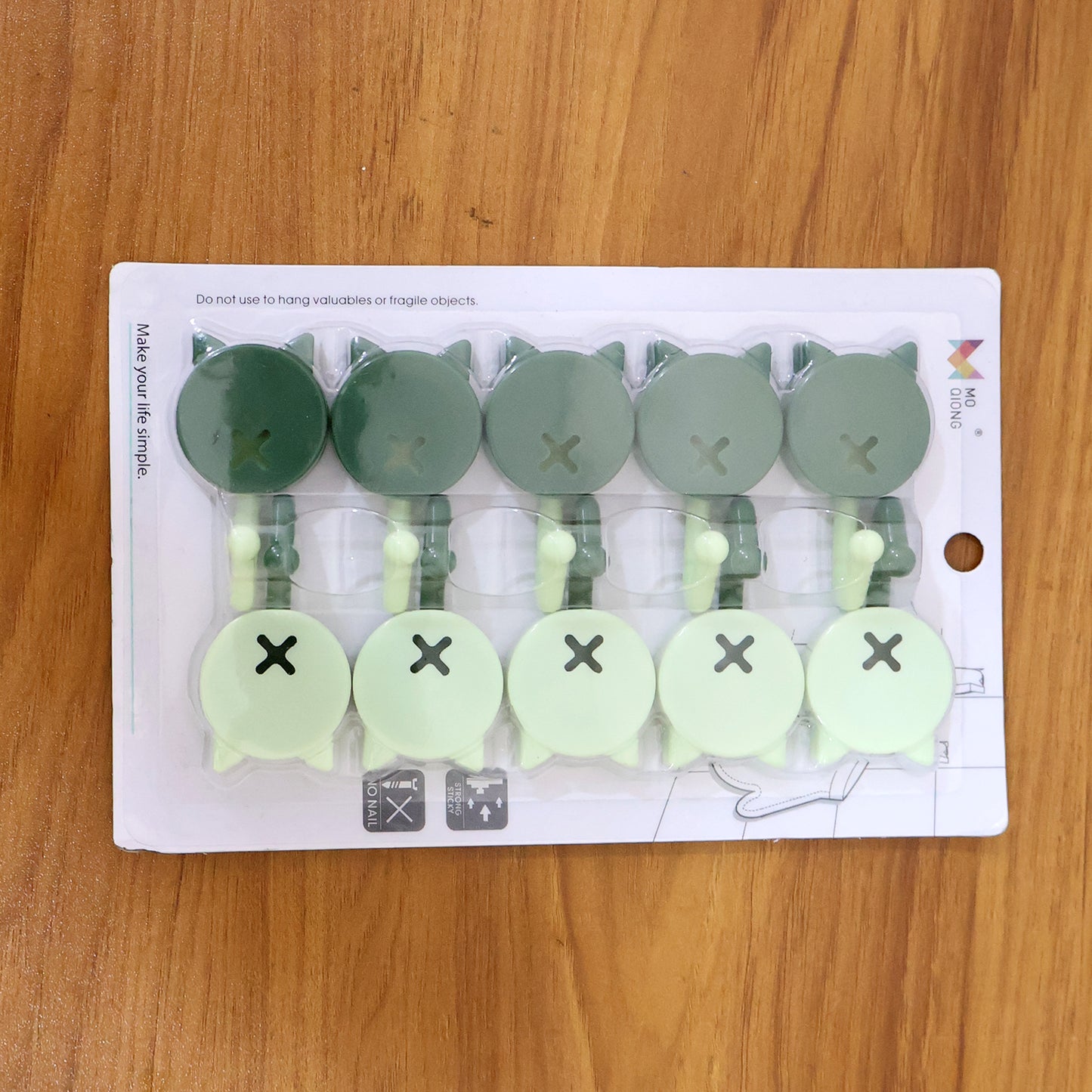 Set of 10 Wukusy self-adhesive round wall hooks for home improvement, showing the hooks attached to a wall surface.