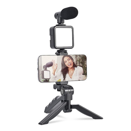 Wukusy 6054 vlogging kit with mini tripod, LED light, phone holder clip, and microphone for mobile video creation.