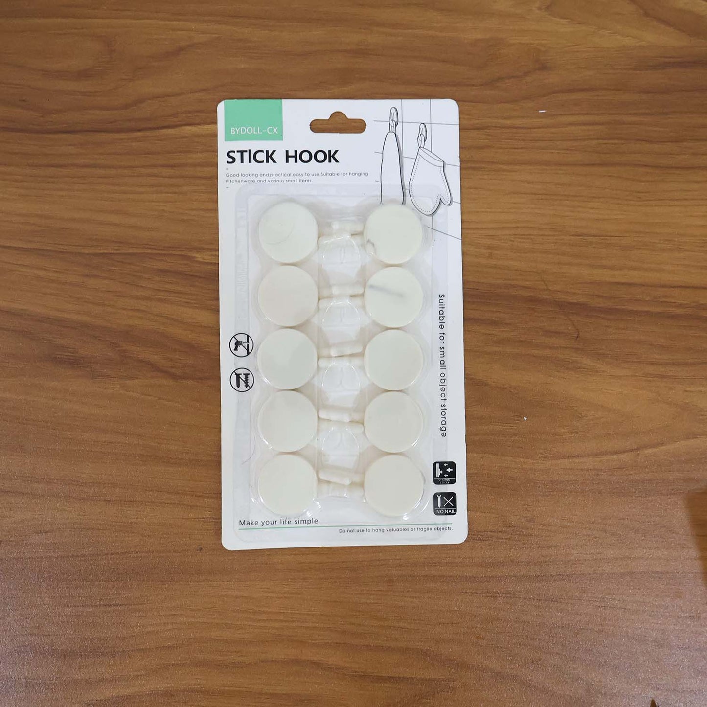 Set of 10 Wukusy self-adhesive round wall hooks for home improvement, mounted on a wall with hooks visible for hanging items.