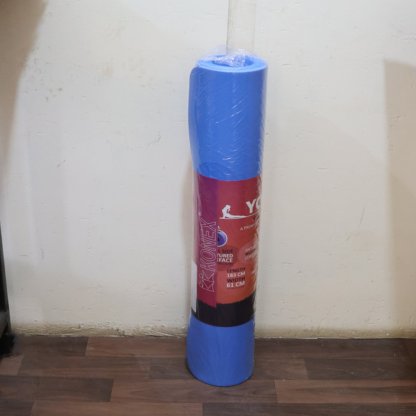 Wukusy premium non-slip yoga mat laid out on a wooden floor, ideal for home or gym workouts, providing stability and comfort.
