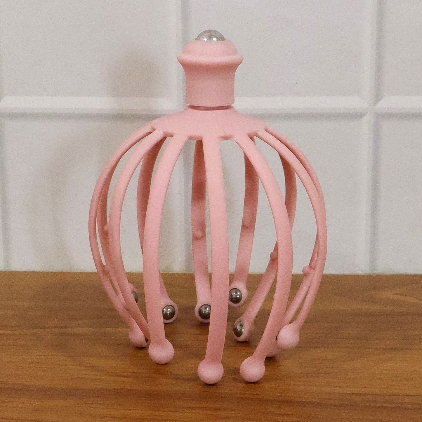 Wukusy manual scalp massager with rolling ball tips for relaxing head and scalp massage, shown in the image.