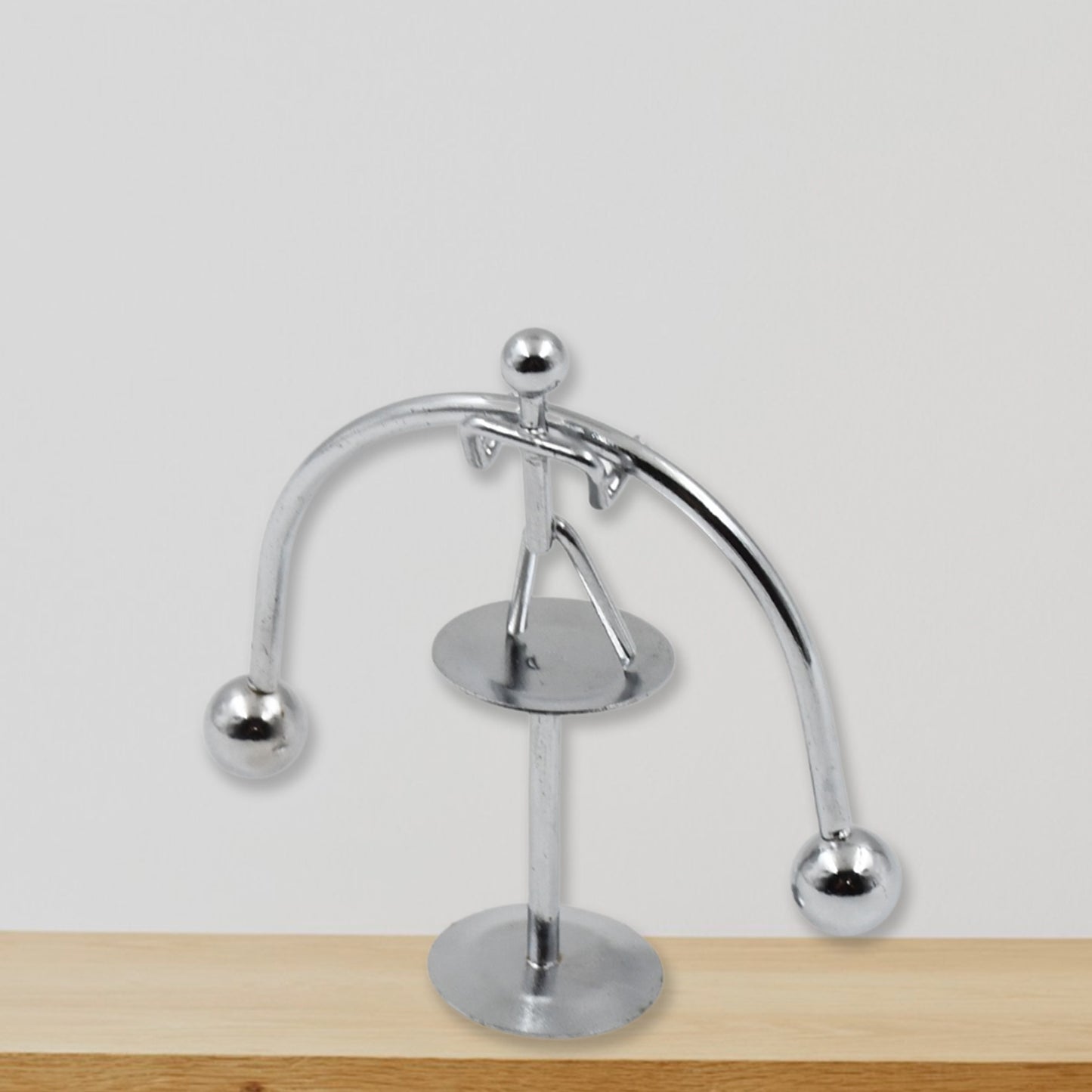 Mini steel balance toy by Wukusy, featuring a small metal weightlifter figurine balancing on a metal frame, ideal for desk decor.