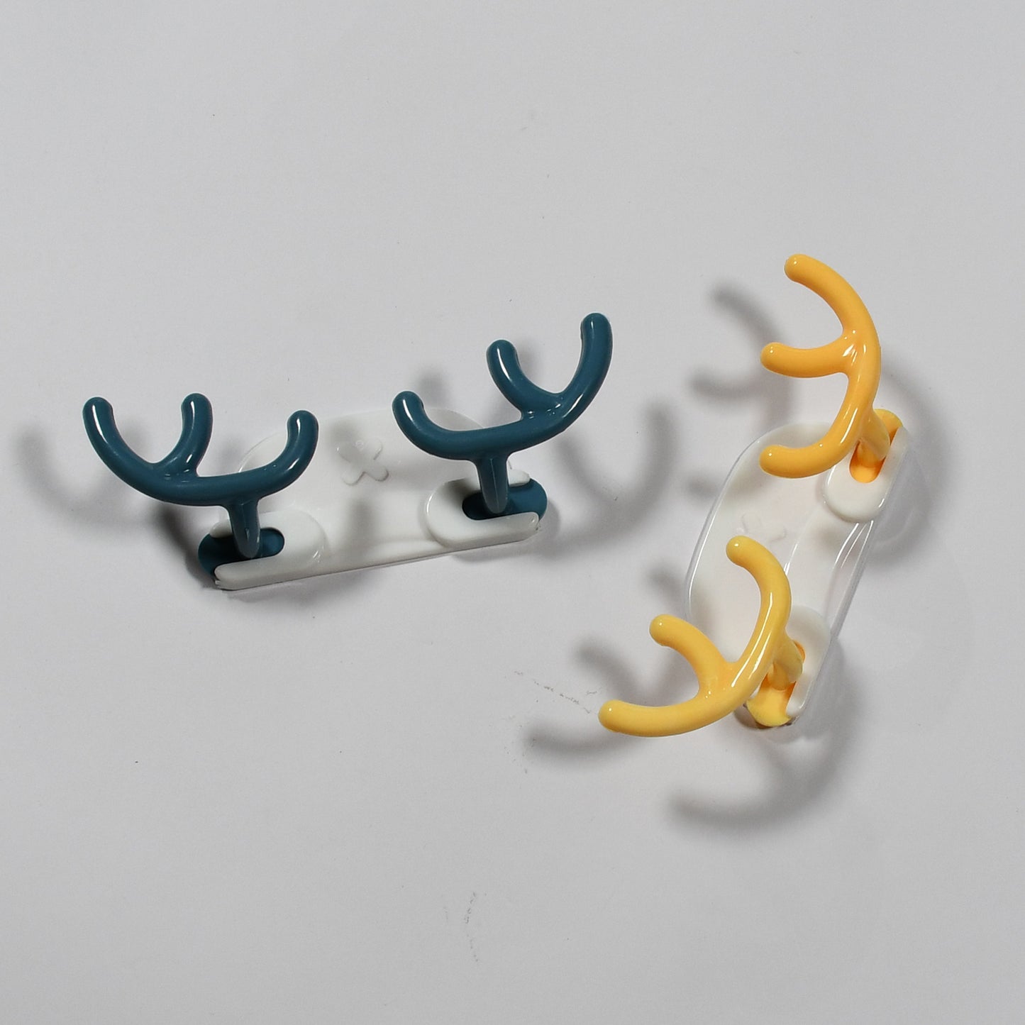 Wukusy 4725 plastic wall hanger hooks with adhesive backing, 4-pack, ideal for home organization and wall mounting.