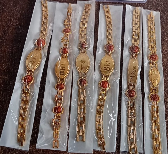 Gold plated metal bracelet rakhi for brother, stylish Wukusy bracelet designed for special occasions.