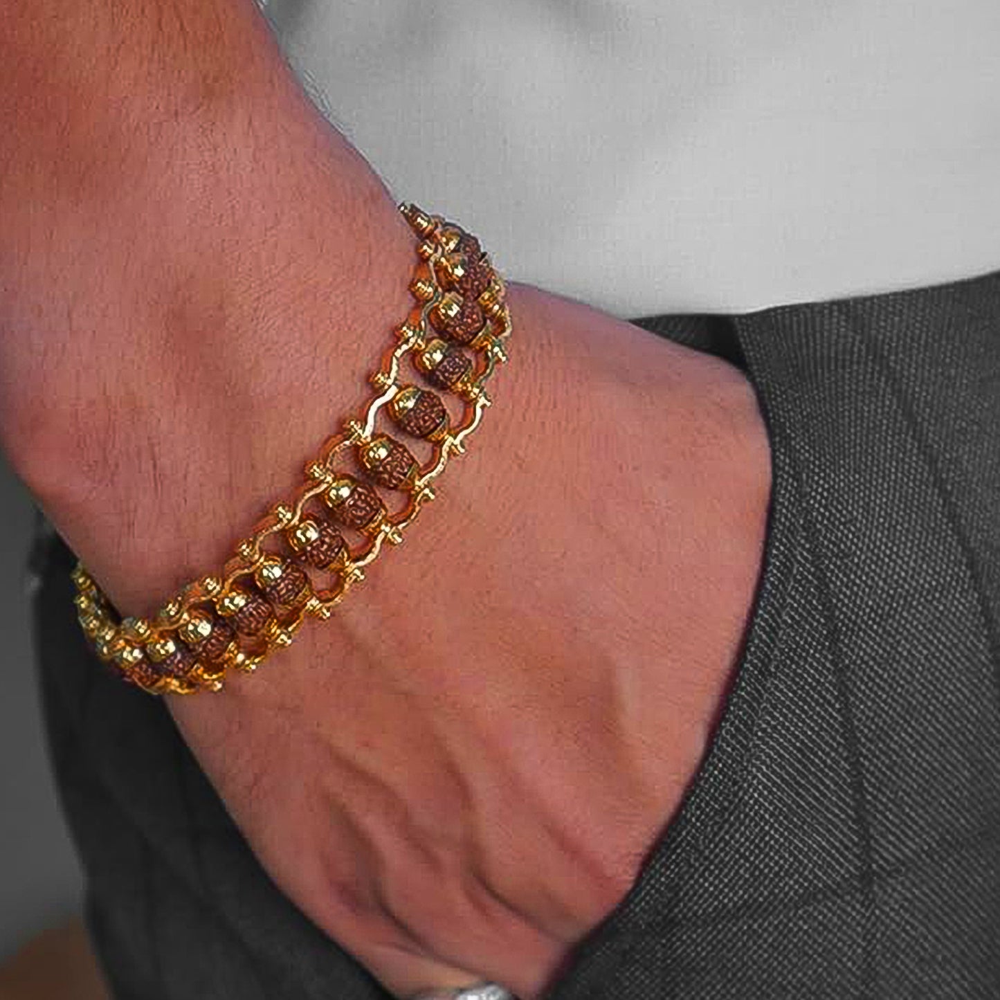 Golden modern Rudraksha bracelet Rakhi for brother, featuring authentic Rudraksha beads and intricate design by Wukusy.