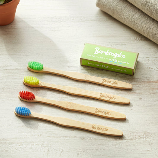 Set of four Wukusy bamboo toothbrushes for adults with eco-friendly handles and soft bristles for gentle brushing.