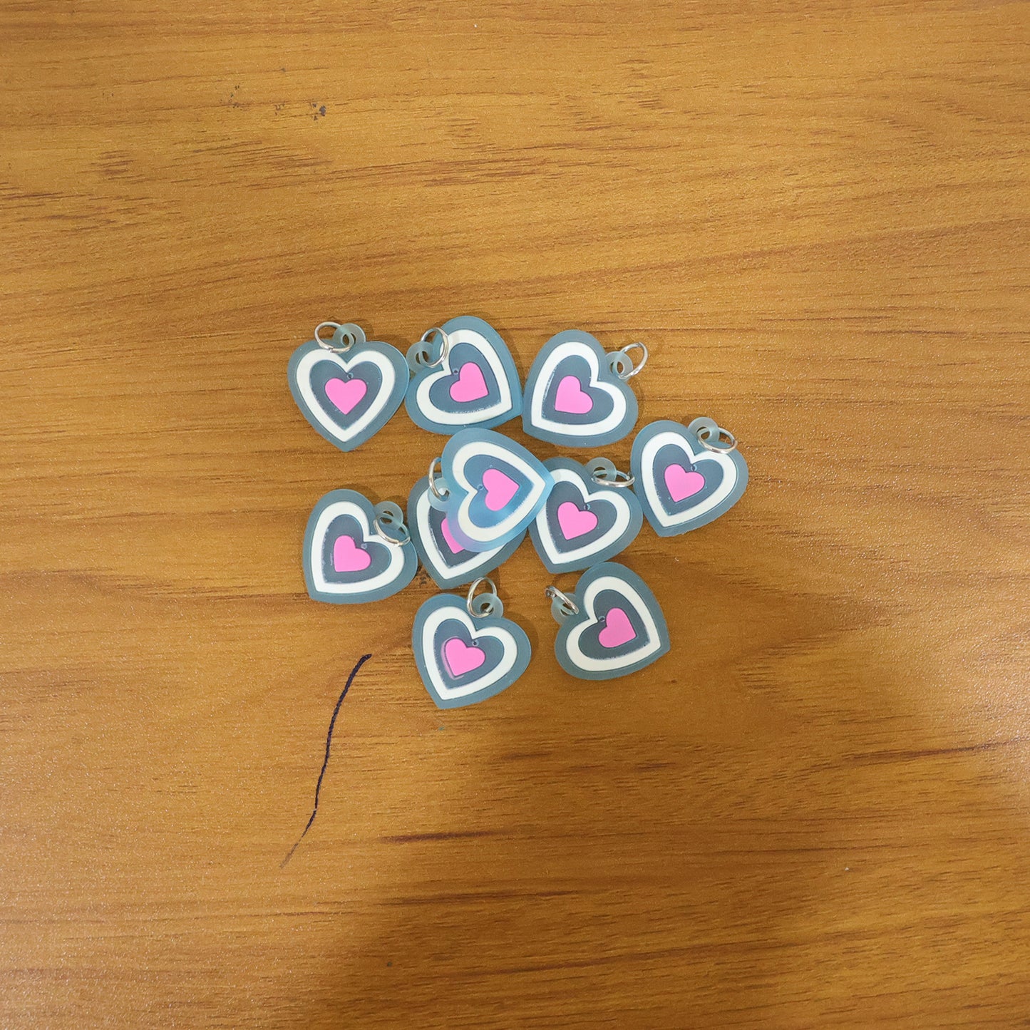 Set of 10 Wukusy cute heart-shaped bag charm keychains with colorful designs, perfect for decorating bags or keys.