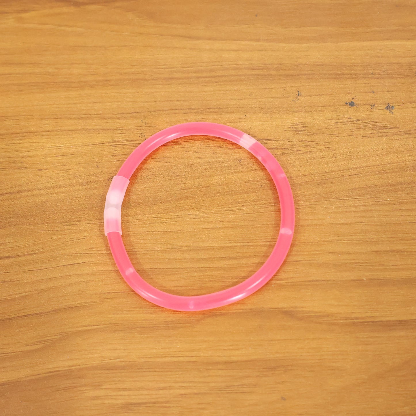 Wukusy glow-in-the-dark light bracelet on a person's wrist, showcasing its luminous design and flexible band.