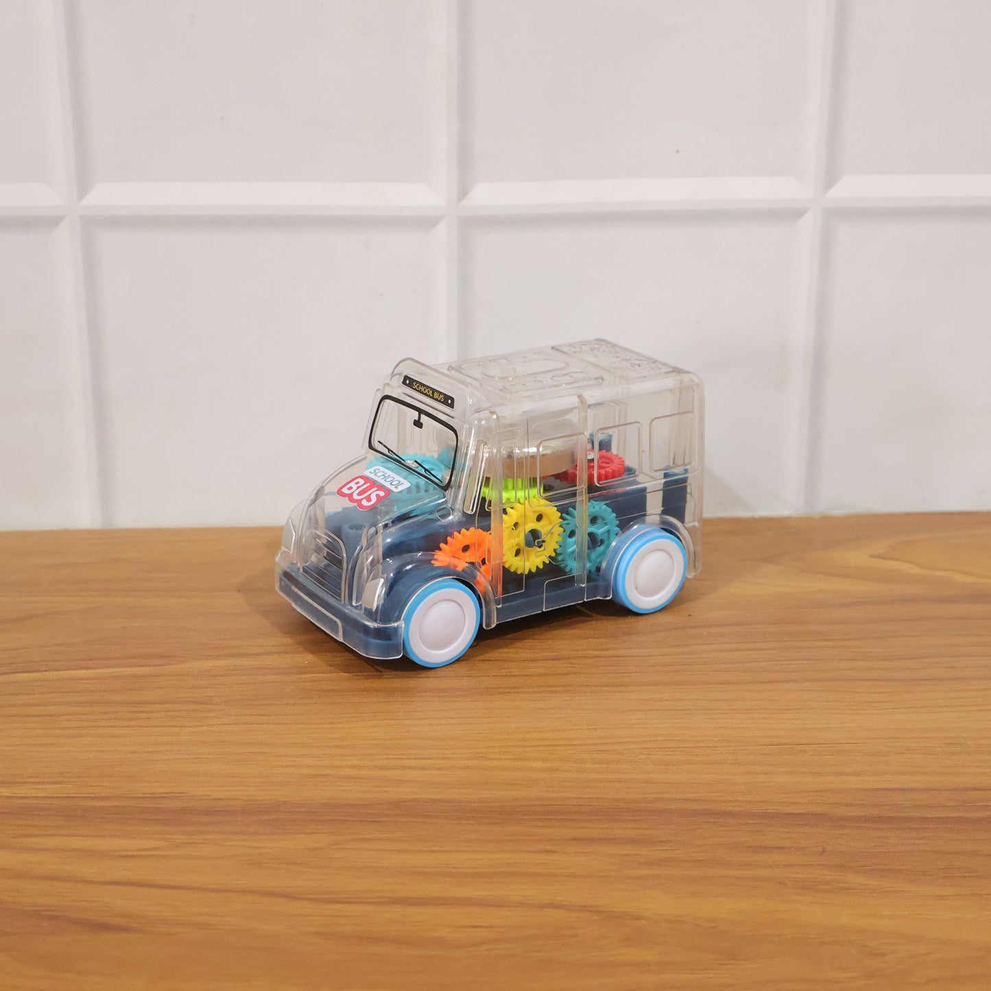 Kids transparent musical light-up school bus toy by Wukusy, featuring colorful lights and detailed bus design for children.