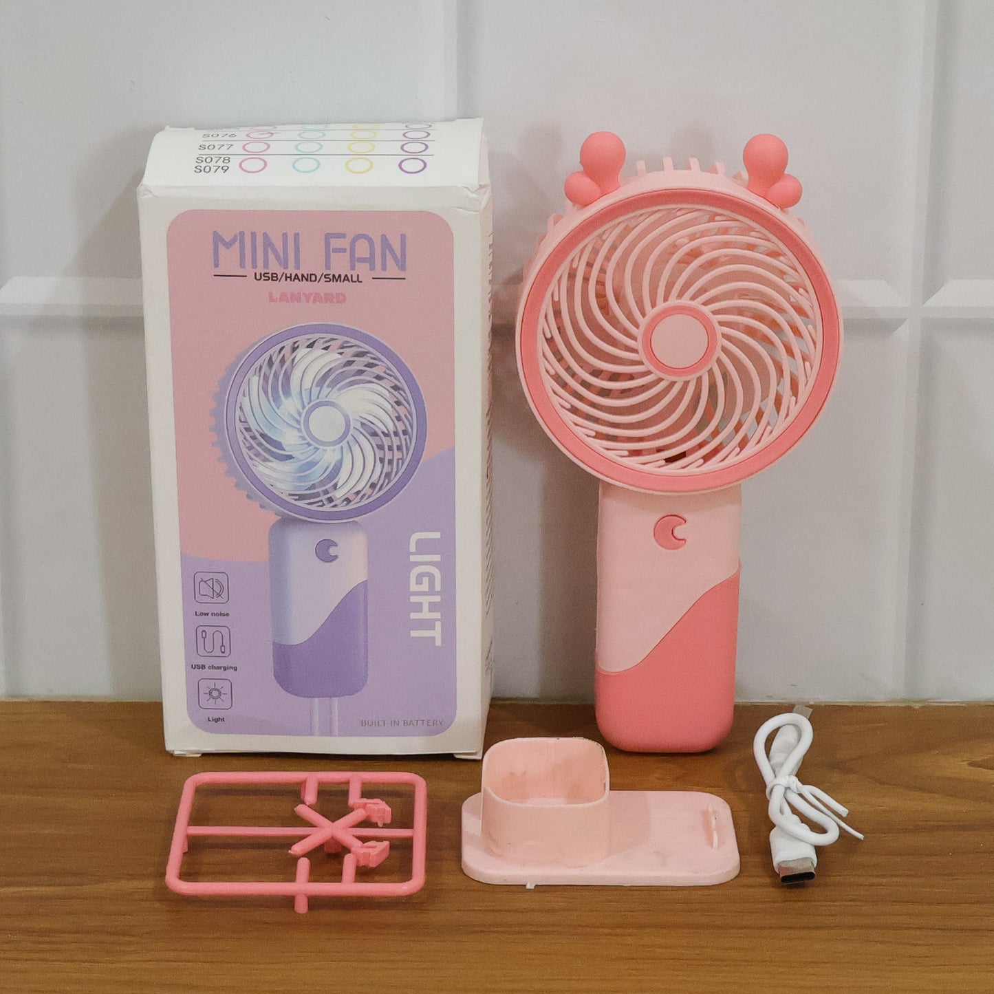Wukusy portable USB rechargeable mini fan with LED light, compact handheld design for personal cooling.
