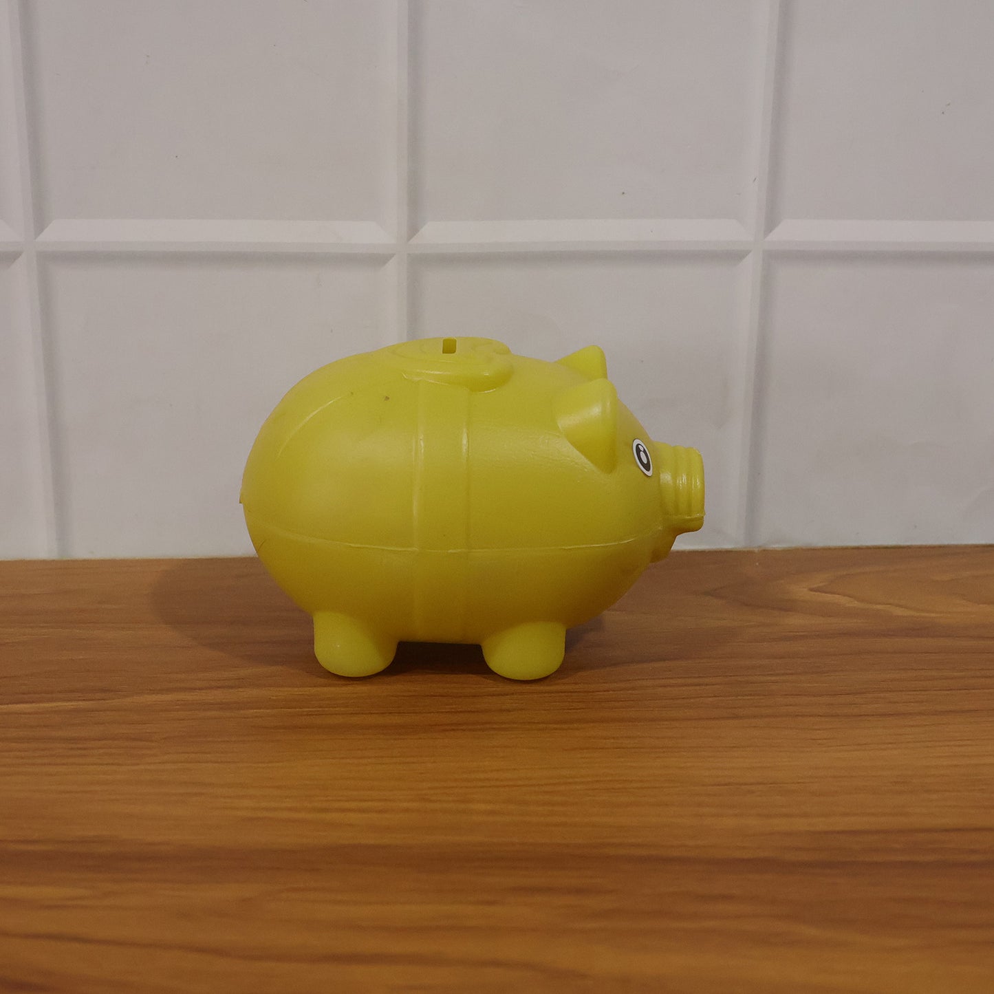 Small Wukusy piggy money bank coin saving box for kids, featuring a cute pig design and secure coin slot.