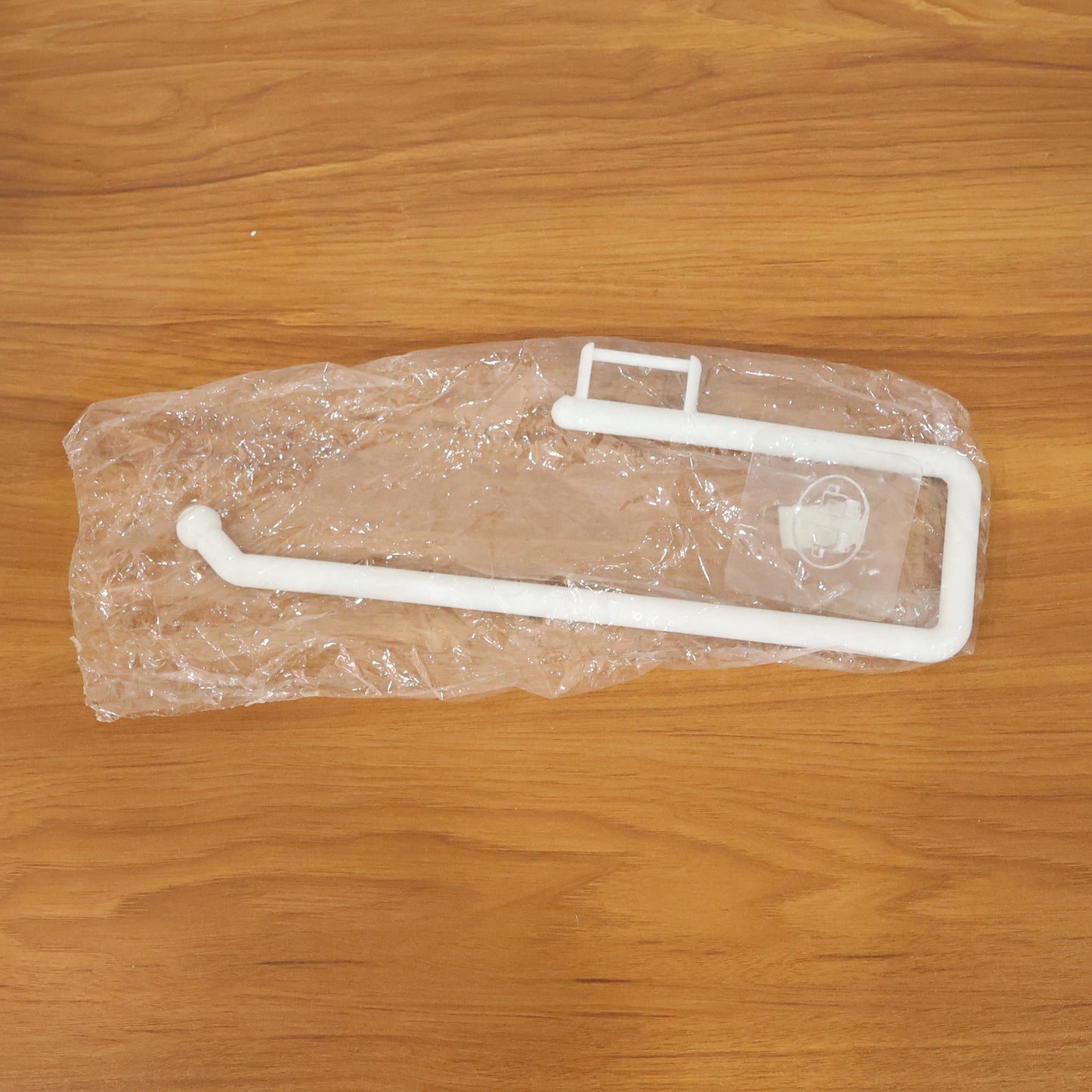 Wall-mounted paper towel holder by Wukusy, featuring a sleek design with a roll of paper towels ready for use.