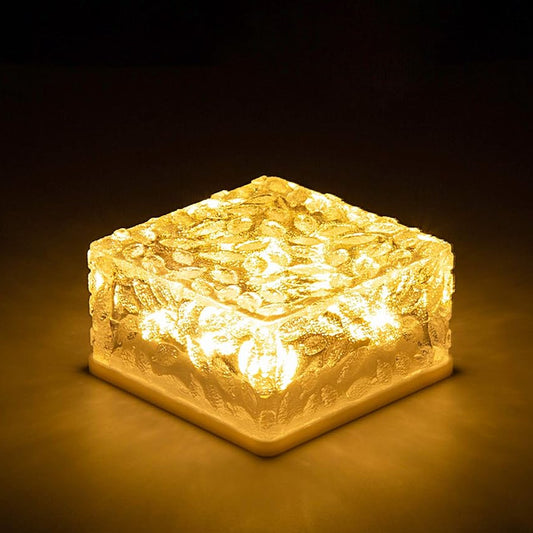 Wukusy ice cube-shaped solar garden light emitting warm glow, perfect for walkway, backyard, Christmas décor, and outdoor parties.