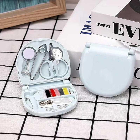 Wukusy mini travel sewing kit with threads, scissors, needles, and a plastic box for emergency sewing and repairs.