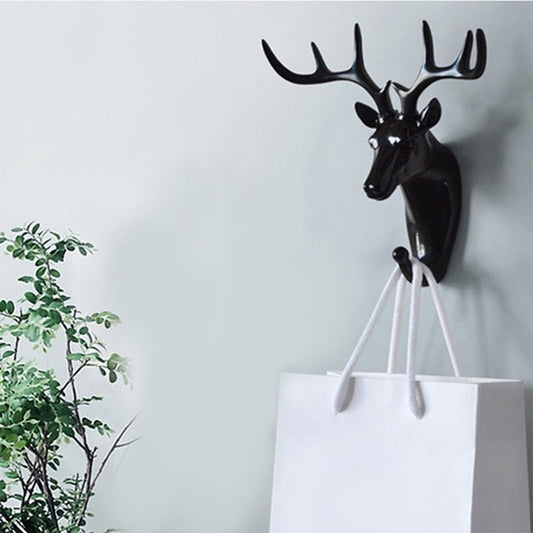 Wukusy 1743 deer head self-adhesive wall door hook hanger for home improvement, mounted on a door with hooks for accessories.