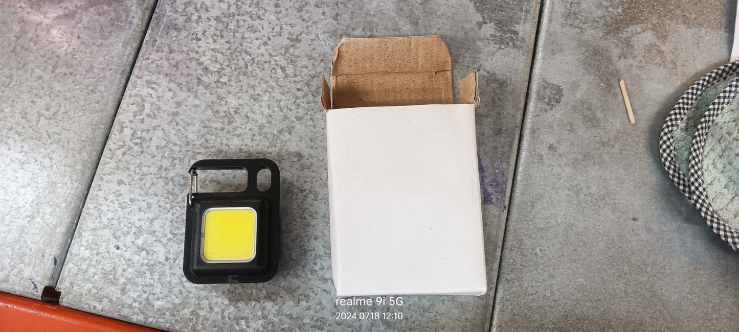 Wukusy LED battery-operated keychain flashlight with folding bracket and bottle opener, ideal for camping, hiking, and emergencies.