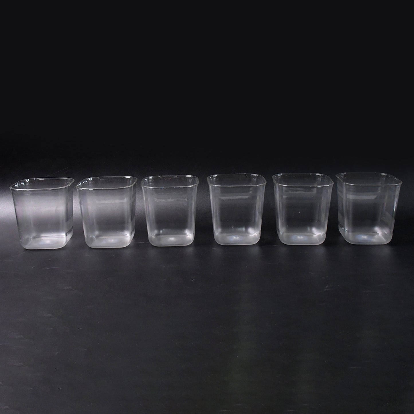 Six transparent diamond-shaped medium serving glasses by Wukusy, ideal for water, juice, and beverages at home.