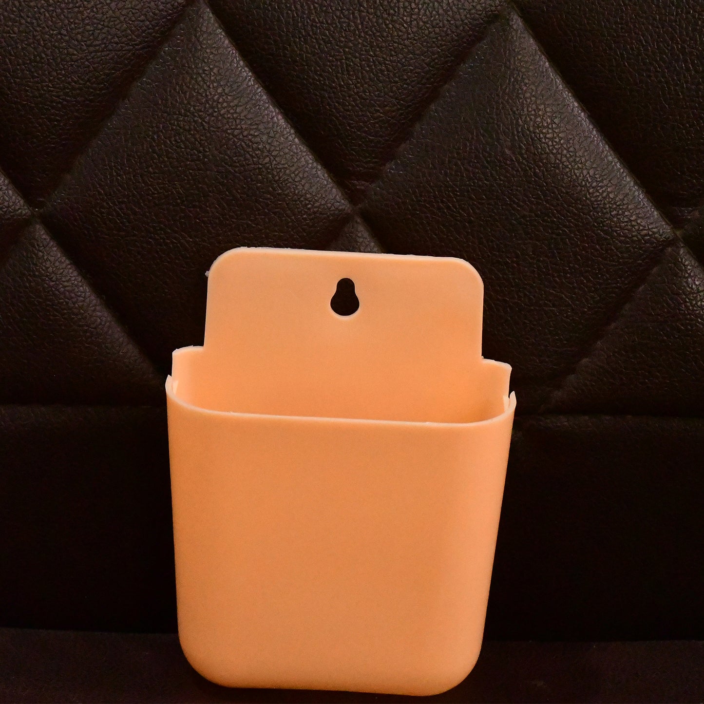 Wukusy multi-purpose wall-mounted plastic storage pocket for home organization, hanging on a wall for easy access.
