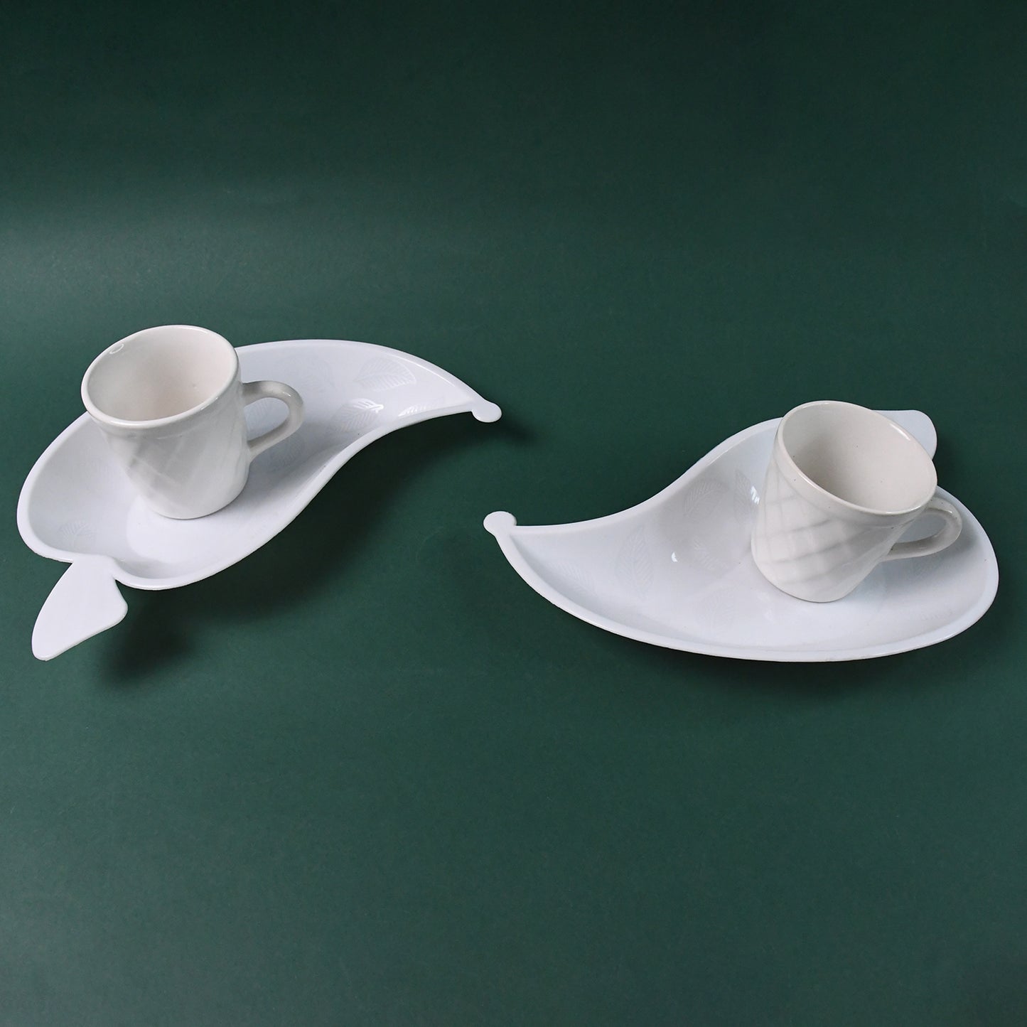 Set of six Unibic ceramic tea cups with a plastic leaf-shaped tray, perfect for serving tea in a stylish home improvement setting.