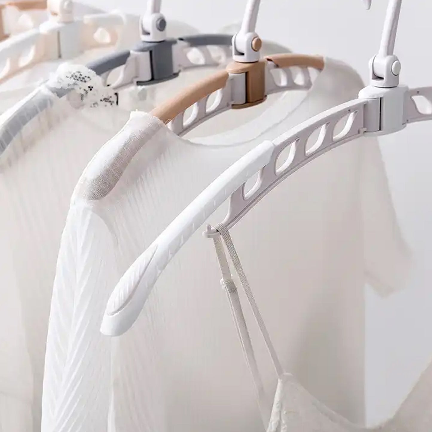 Wukusy portable folding clothes hanger with 360-degree rotation and adjustable arms, ideal for travel and drying clothes.