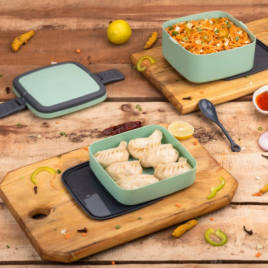 Green double-layer portable lunch box by Wukusy with a carrying handle and spoon, designed for convenient meal storage.