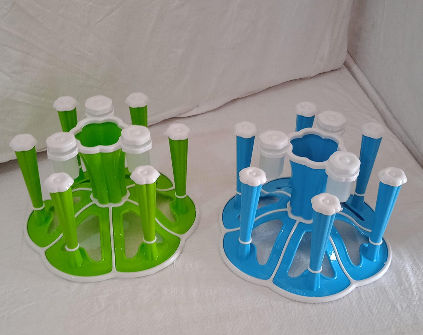 Wukusy plastic glass stand holding six tumblers on a kitchen dining table with pepper and salt shakers in a home kitchen setting.