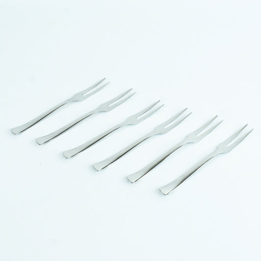 Wukusy Apex 6-in-1 stainless steel fruit fork set with multiple tines for serving and eating fruit in a modern kitchen setting.