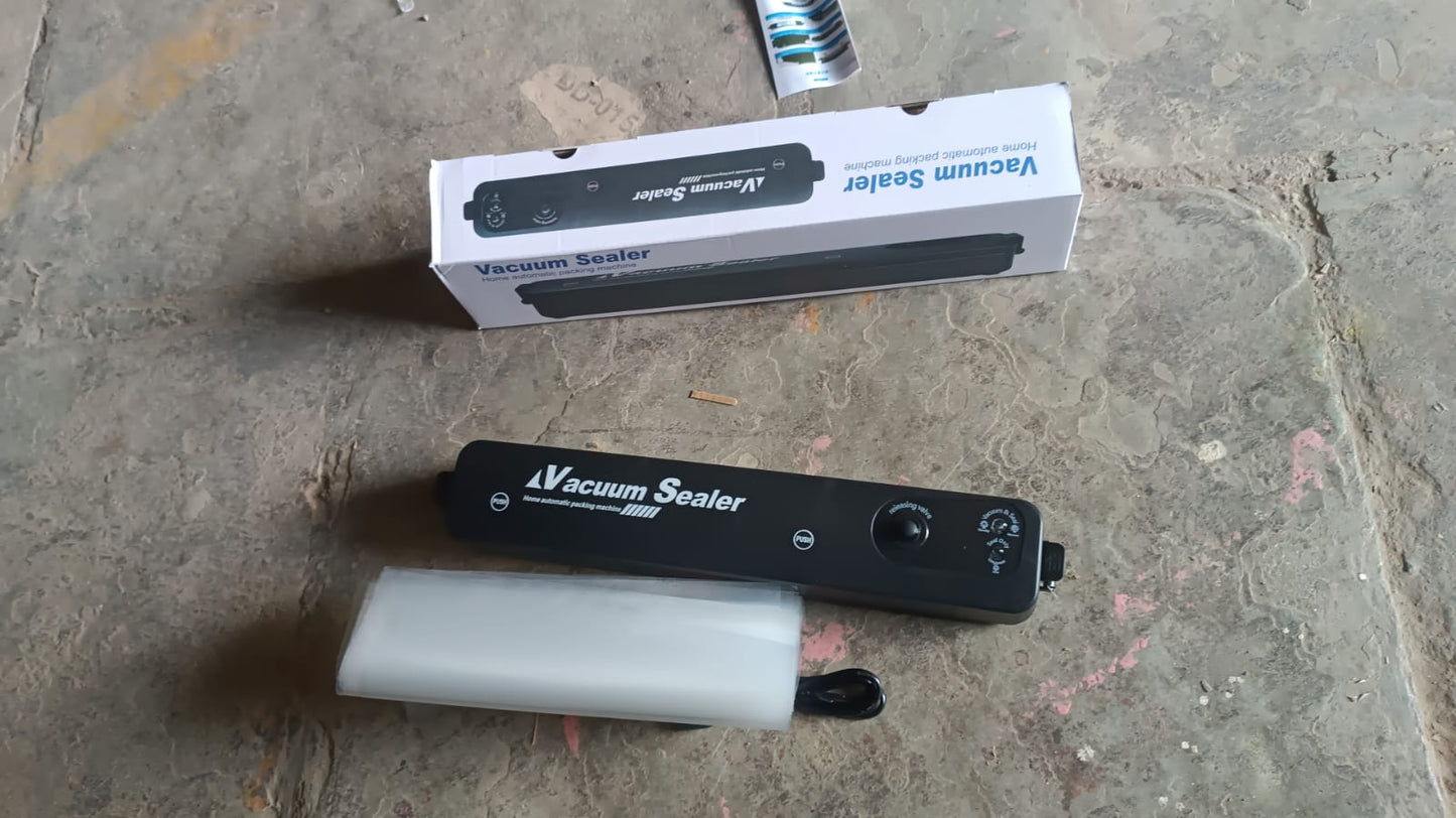 Wukusy vacuum sealer machine with 10 sealing bags for home kitchen use, shown on a countertop in a modern kitchen setting.