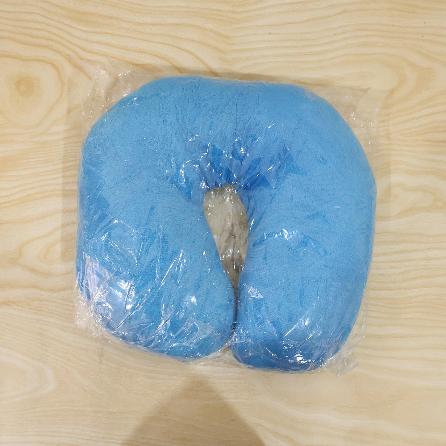 Blue U-shaped Wukusy travel neck pillow showing soft foam interior and supportive design for neck comfort during travel.
