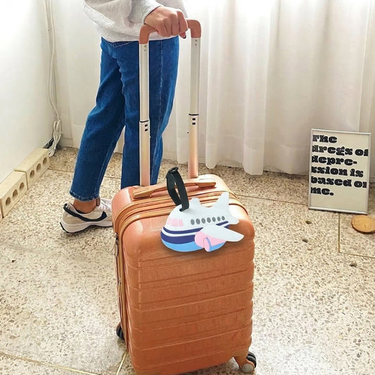Wukusy airplane shape travel luggage bag tag with airline design, durable plastic, and secure strap for easy identification.