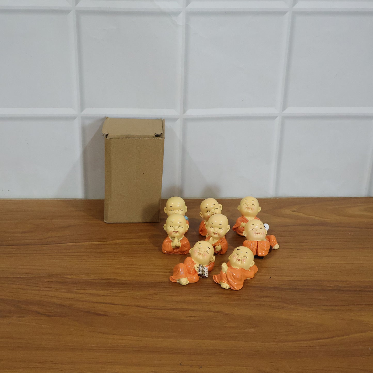 Eight miniature Wukusy Monk Buddha idols in a set, featuring detailed, serene Buddha figures ideal for home or spiritual decor.
