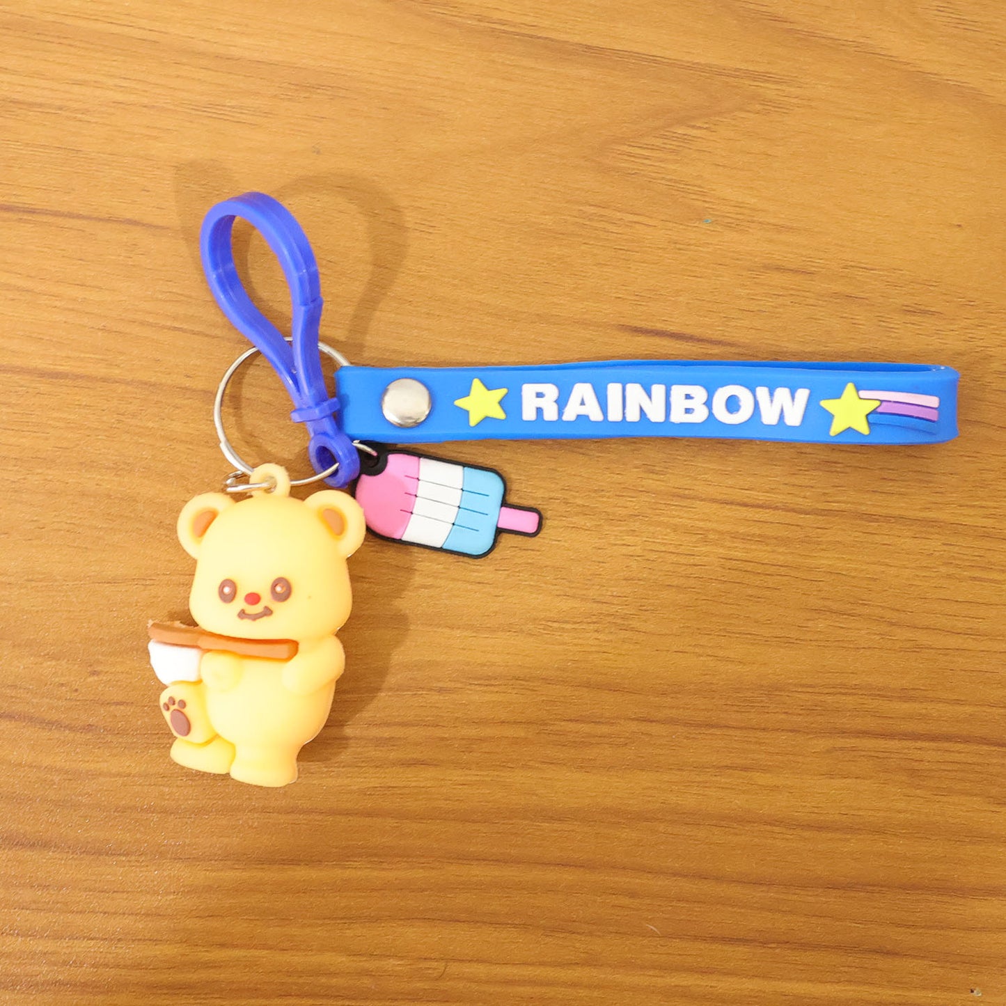 Cute bear cartoon keychain with rainbow strap by Wukusy, featuring a adorable bear design on a colorful keyring.