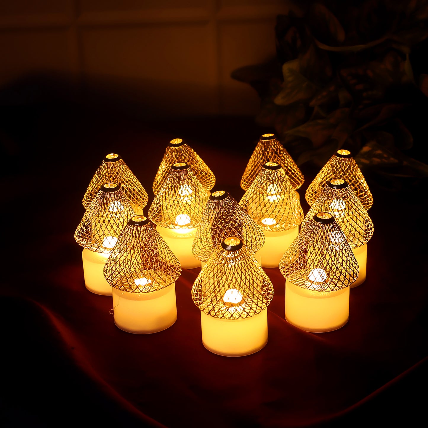 Set of 12 Wukusy decorative LED flameless candle lights with golden net covers, ideal for home decor and ambient lighting.